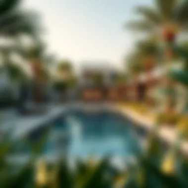 Serene Pool Area Surrounded by Nature Tranquil pool area amidst lush greenery at Water Edge Yas